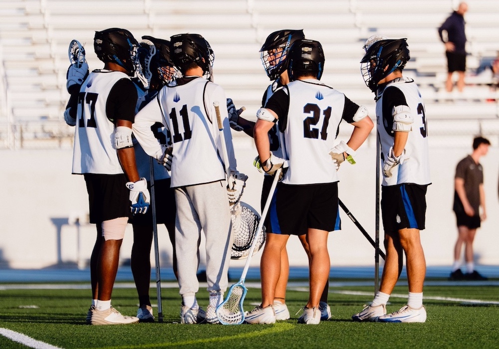 lacrosse players in a huddle